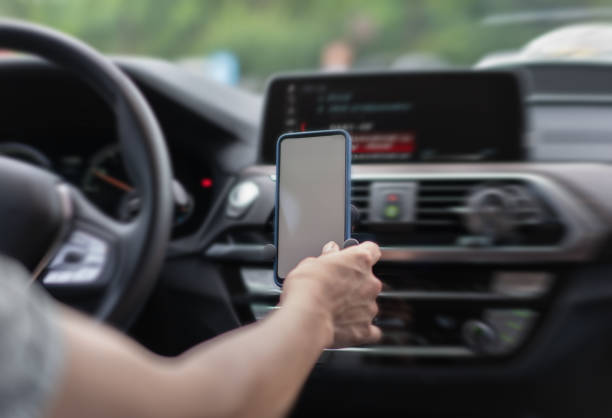 istock The driver is using the mobile phone on the mobile phone holder in the car 1326826884