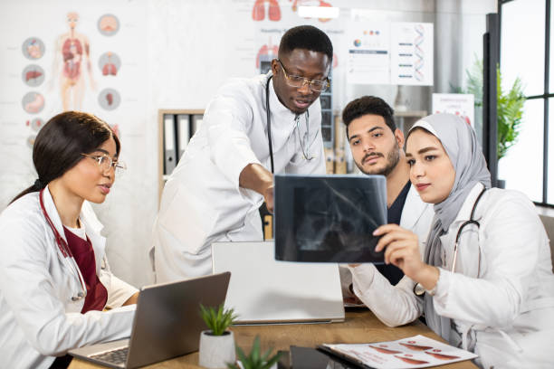 istock Multiethnic doctors analyzing x ray scan of patient lungs 1326831551