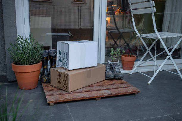 istock Cardboard package delivery at patio door. 1326831615