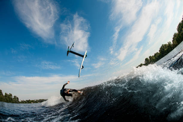 istock view of flying foilboard above wave and man who fell from it 1326832724