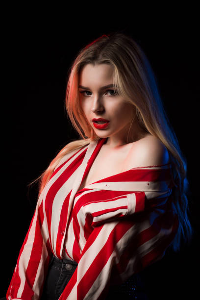 istock Amazing blonde girl with red lips posing with closed eyes at studio 1326833652