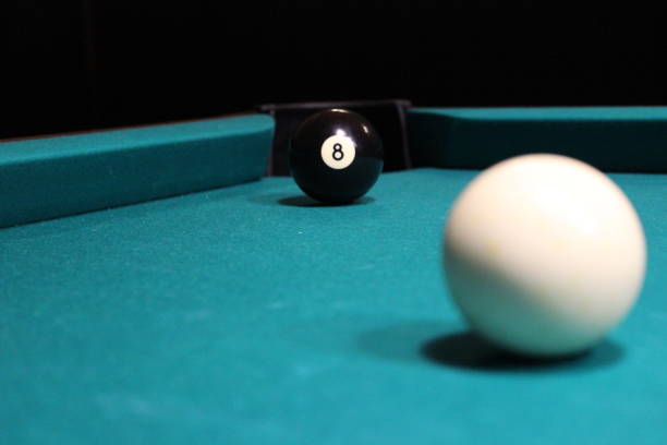 istock Black billiards ball near with hole 1326833750