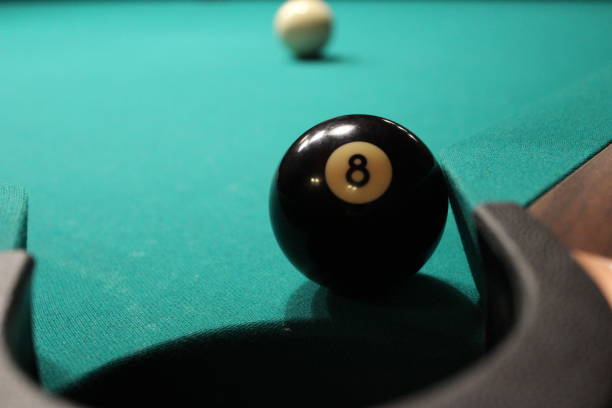 istock Black billiards ball near with hole 1326833753