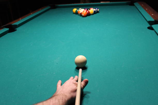 istock Cue aim billiard snooker pyramid on green table. American billiards pool on a green table 1326833796