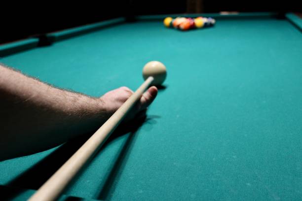 istock Cue aim billiard snooker pyramid on green table. American billiards pool on a green table 1326833798