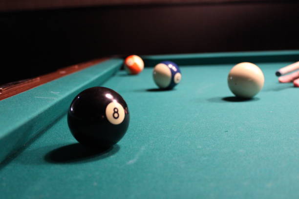 istock Cue aim billiard snooker pyramid on green table. American billiards pool on a green table 1326833812