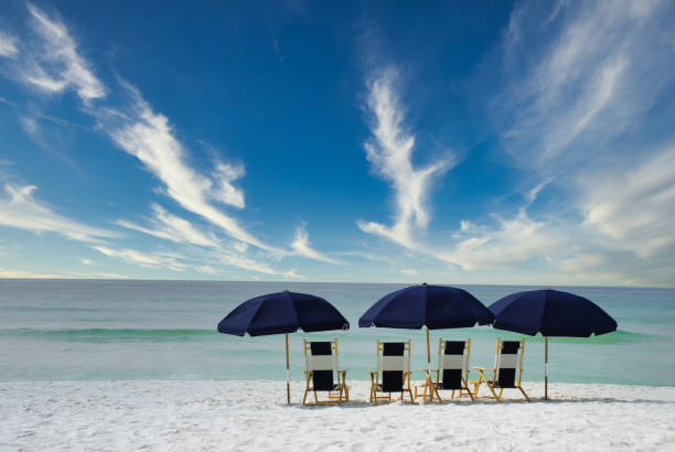 istock Umbrellas and beach chairs on white sand 1326834712