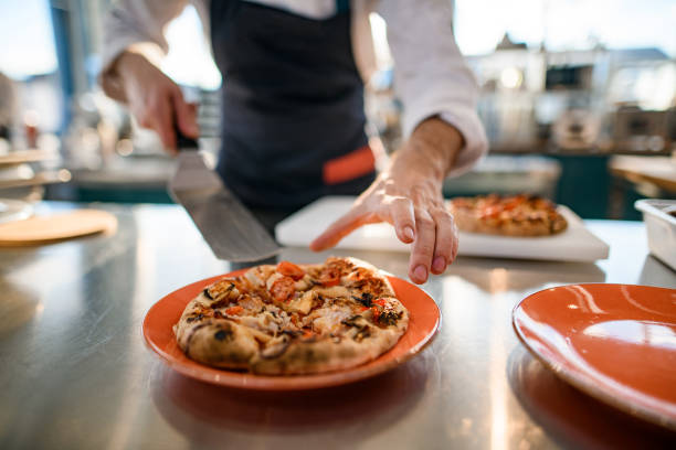 istock selective focus on delicious small round cut pizza in plate. 1326835914