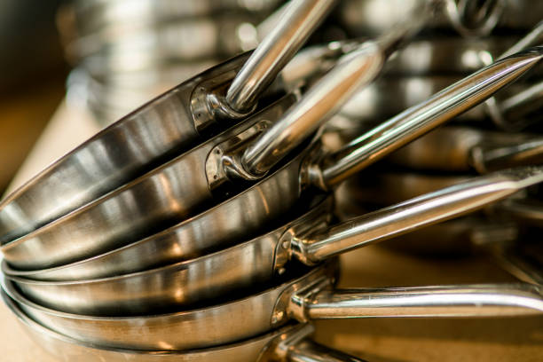 close-up of clean pans on top of each other. Kitchen equipment and utensil stock photo