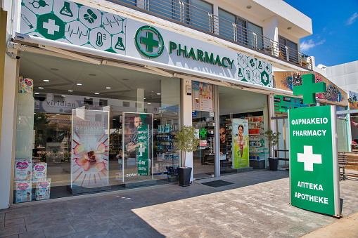 Ayia Napa, Cyprus - May 23, 2021: Pharmacy facade on summer sunny Nissi Avenue in city center. Ayia Napa is a tourist resort at the far eastern end of the southern coast of Cyprus.