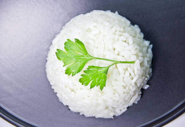 Close up of a plate of Turkish Pilaf - Pilav pirinç pilavı Cooked basmati rice served in a ceramic bowl or plate on white background. pilau rice stock pictures, royalty-free photos & images