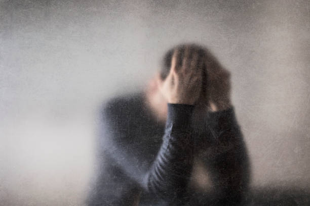 istock Depression. Broken man behind a dusty scratched glass. 1326844358
