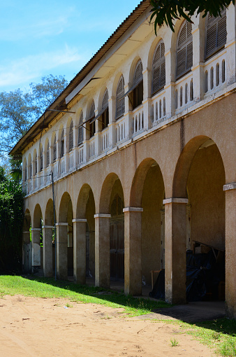 Grand-Bassam, Aboisso department, Sud-Comoé region, Comoé district, Ivory Coast / Côte d'Ivoire: frontage of old public building with arcade and loggia on Rue Bouët - French colonial architecture of the Quartier France, Historic Town of Grand Bassam - UNESCO world heritage site.