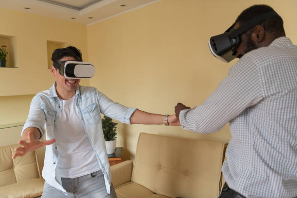 istock Cheerful Man and his African Friend are Browsing a Virtual World with Virtual Reality Goggles. 1326852643