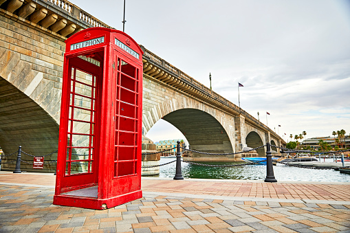 Lake Havasu, Arizona, USA - June 30, 2021: Antique red phone booth at the London Bridge in Lake Havasu, Arizona