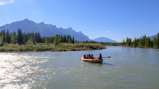 Friends float down Bow River in inflatable raft