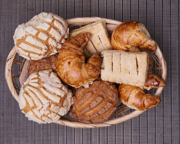 breads in a basket with rich chocolate in a clay cup - pastry imagens e fotografias de stock