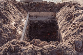 istock Freshly dug grave pit at cemetery, a close-up 1326858979