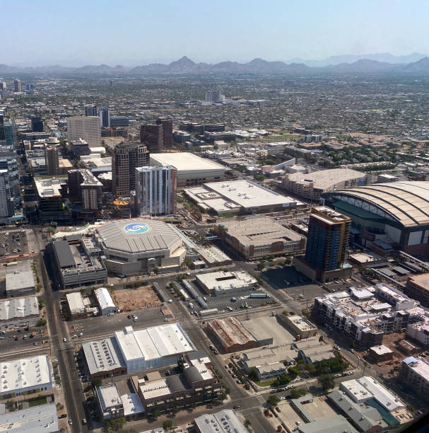 Downtown Phoenix Arizona Phoenix, Arizona, USA - June 18, 2021: A view of downtown Phoenix Arizona showing skyscrapers and sports stadiums. Phoenix Headhunters stock pictures, royalty-free photos & images