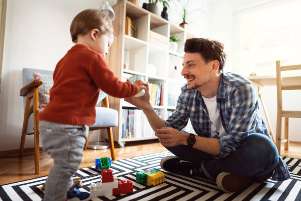 istock Father and son playing at home 1326861874