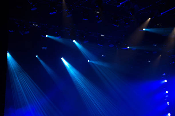 istock Blue stage lights glowing in the dark 1326861951