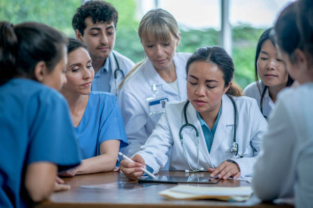 istock Group of medical professionals discuss 1326862219