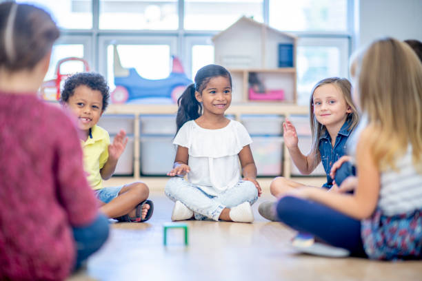 istock Multi ethnic preschool children seated on classroom floor together 1326865185