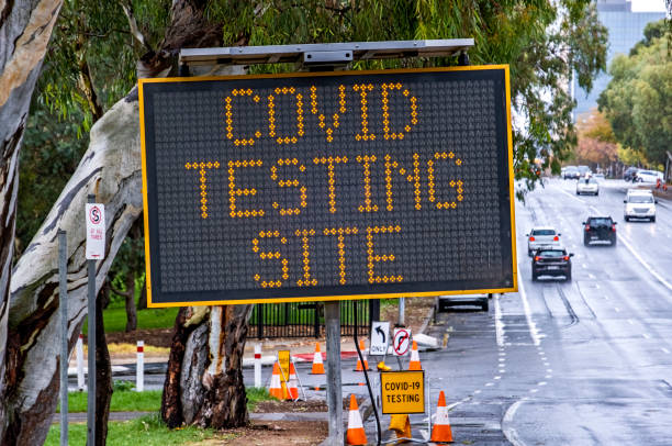istock Close-up temporary Covid Testing Site illuminated sign on wet winters day 1326865240