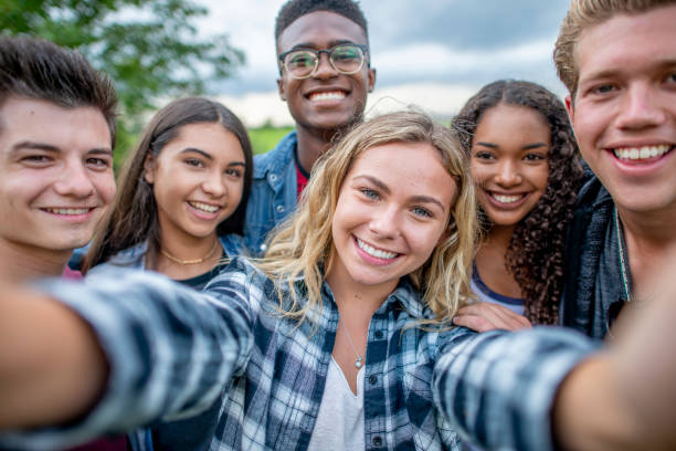 istock Multi ethnic teenagers taking a group selfie 1326868328