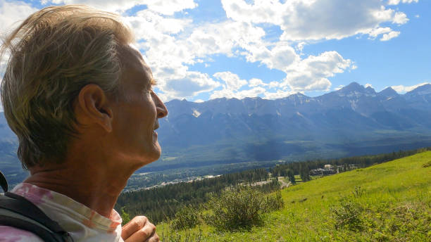 istock Man hikes along grassy mountain ridge in summer 1326868339