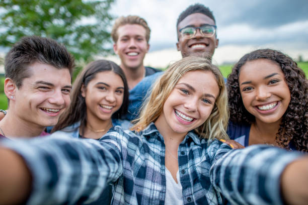 istock Happy and smiling teenagers taking a group selfie 1326868340
