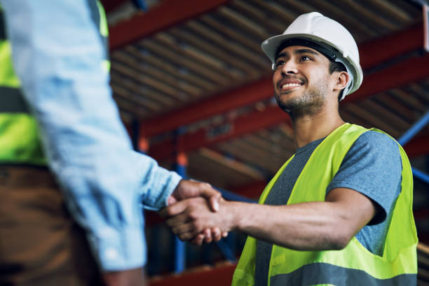Shot of two builders shaking hands at a construction site Trust, respect and reliability, everything great partnerships are built on hiring stock pictures, royalty-free photos & images