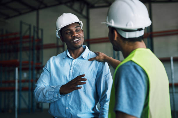 Shot of two having a conversation in a warehouse