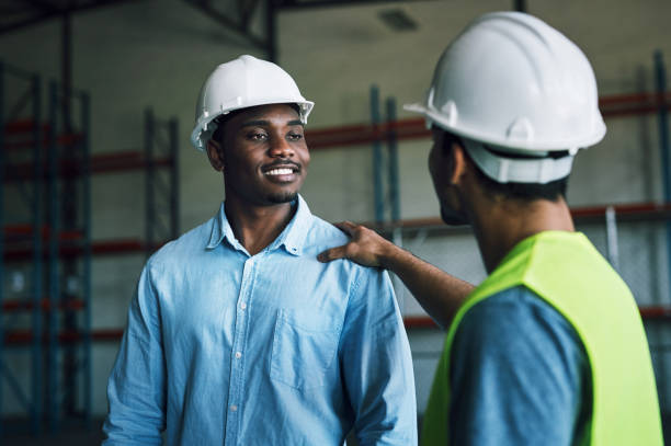 istock Shot of two having a conversation in a warehouse 1326874016