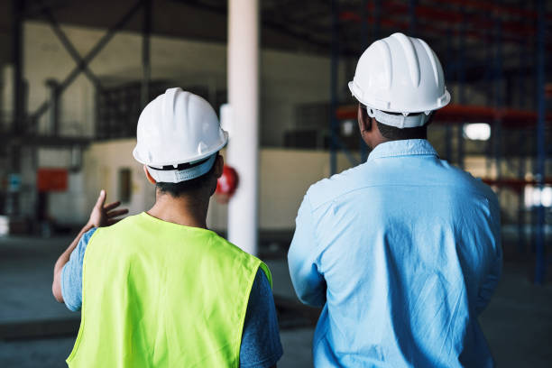 istock Shot of two builders inspecting a construction site 1326875011