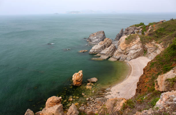 istock coastal bay with big rocks surrounded by sea water 1326876819