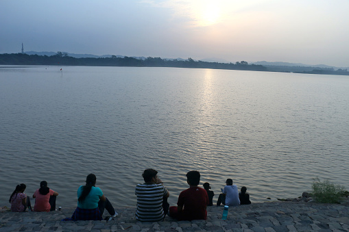 Visitors enjoying sunrise sitting on the bank of Sukhna Lake in Chandigarh on July 04, 2021. A View of Sunrise at Sukhna Lake..