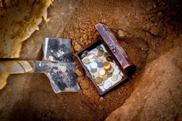 Find treasure with money using shovel stock photo
