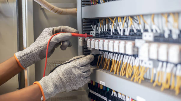 istock Electrician engineer uses a multimeter to test the electrical installation and power line current 1326896457