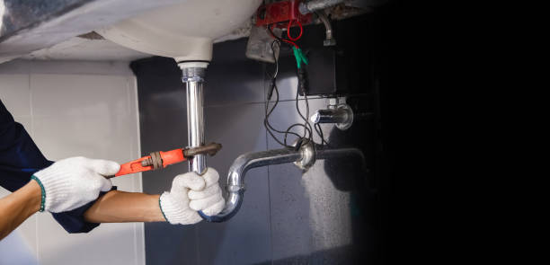 istock Plumber fixing white sink pipe with adjustable wrench. 1326896467