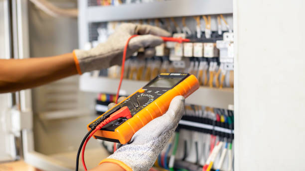 istock Electrician engineer uses a multimeter to test the electrical installation and power line current 1326896489