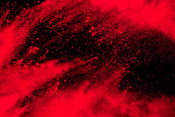 istock Red particle explosion on black background.Freeze motion of red dust splash. 1326900696