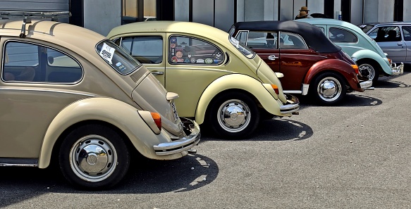 Azzida, Italy. July, 3 2021.  Side and back of a group Volkswagen Type 1 cars , better known as beetle, parked on the roadside. They are  waiting to participate in a collector's car auto gathering later.