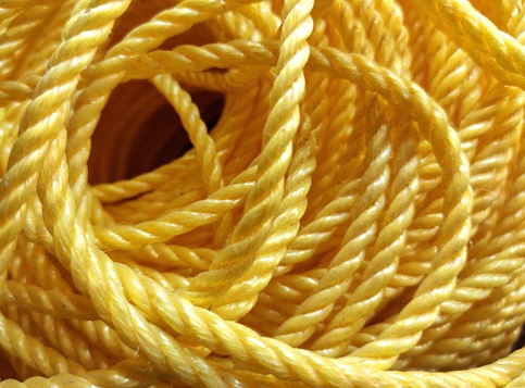 Yellow nylon rope bundle background, twisted rope