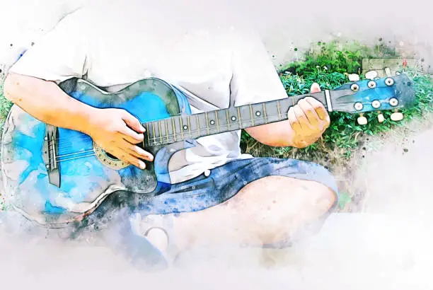 Photo of Colorful acoustic guitar on watercolor illustration painting background.