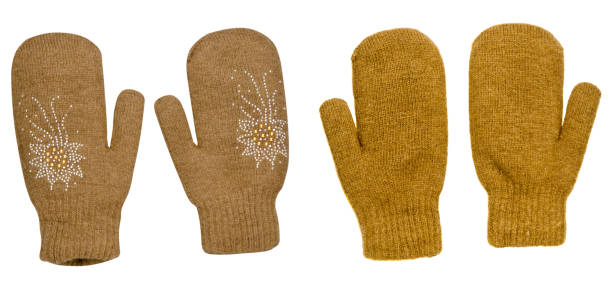 two pairs dark yellow mittens isolated on white background. Knitted mittens. Mittens top view.mittens mustard color