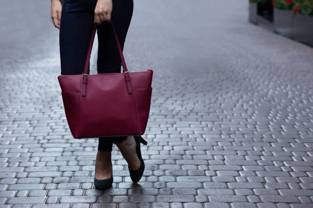 istock Woman holding red purse 1326908812
