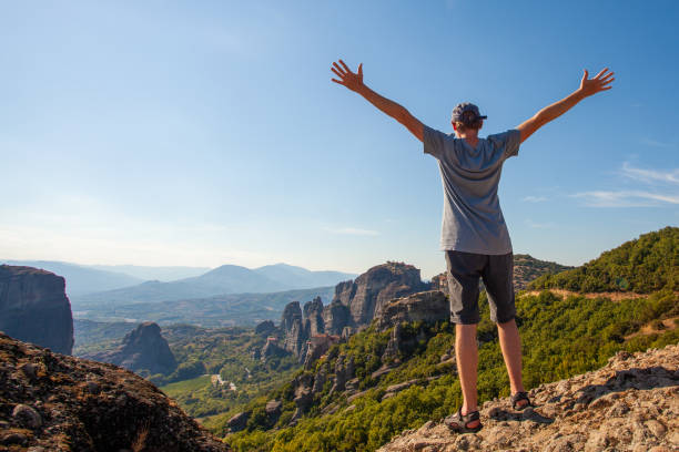 istock Young man overlooking mountain and sky and enjoying vacation 1326910864