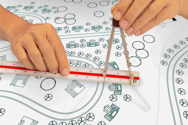 istock landscape architect student use dividers and scale ruler on blueprint  in class. 1326910896