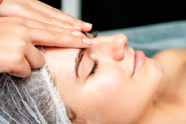istock Female therapist making forehead massage 1326911979